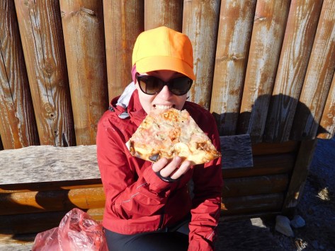 Ally feeding her legs with the world's biggest slice of pizza